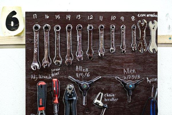 Each workstation tool board is equipped with common bike tools.