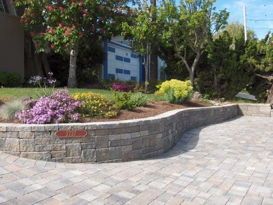 Hallmark Fine Gardens installed wall block and pavers to transform this yard into a beautiful show piece