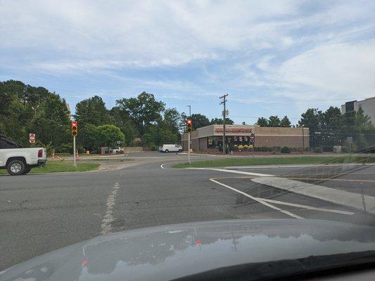 Outside. Unusual intersection right in front of the store facing 15-501 and Service Rd.