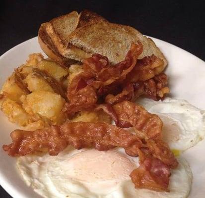 Eggs over easy, home fries, bacon & toast!