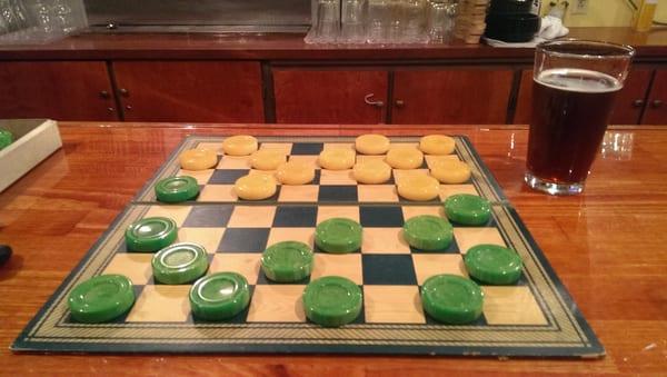 Nice friendly game of checkers on a rare 'Bakelite' checkers with really cool colors green and yellow.