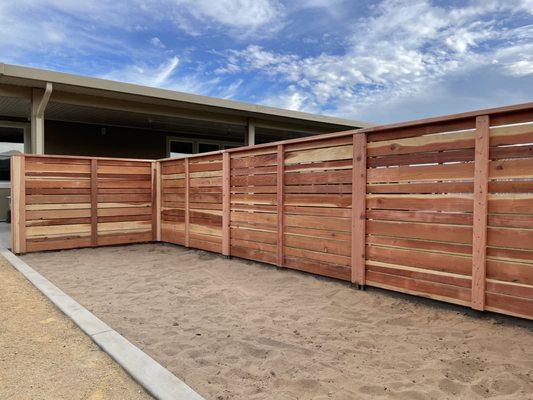 Custom redwood "stockade" fence with Steel posts.