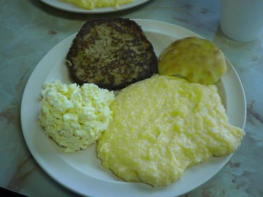 Salmon patty, eggs, cheese grits, and a biscuit