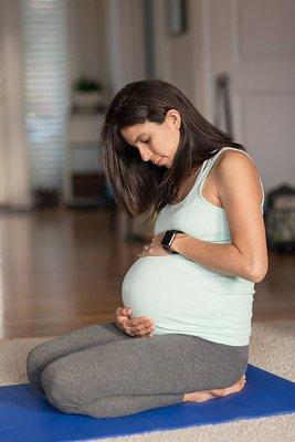 Pregnant woman practicing yoga.