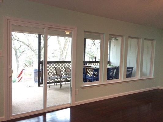 After photo: new sliding door, new big windows, replaced flooring where the hearth had been