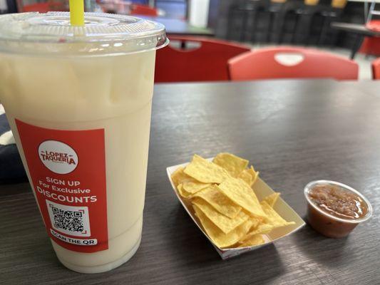 Horchata drink and complimentary tortilla chips and salsa.