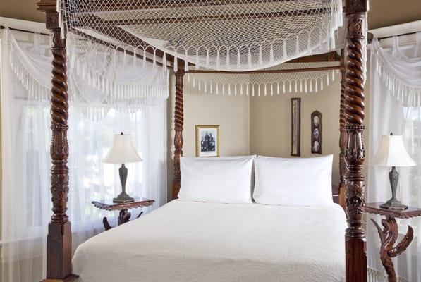 The Franz Huning Room on the second floor has a queen canopy bed and clawfoot tub with shower and chandelier in the bathroom.