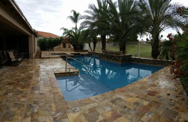 New Travertine pavers,water feature and fireplace!