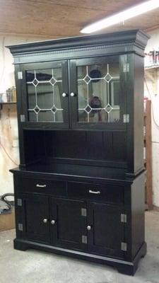 A hutch that was a golden oak refinished in black lacquer