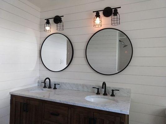 Updated bathroom with shiplap walls, new vanity and lights