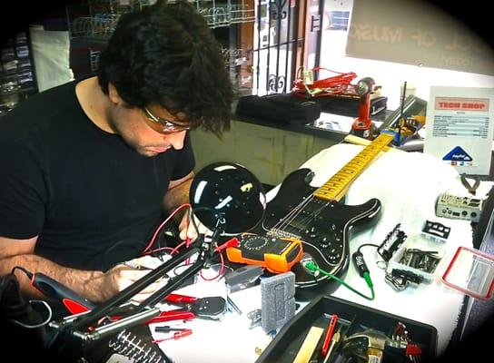 Julian works on a Fender Strat in the Tech Shop.