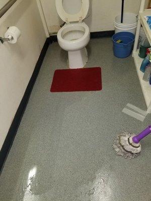 Flooded bathroom forcing clients to use neighboring bathrooms and smells the building up.