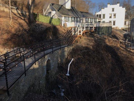 A view of the historic family home, distilling house, and the magnificent dry stack limestone dam.