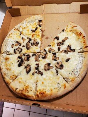 This is supposed to be a full topping white pizza with mushrooms. Over an inch and half of crust???? And a scatter of mushrooms....