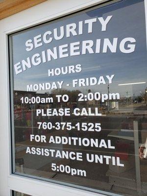 Front door signage with hours