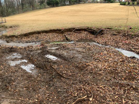 Creek/ property & footbridge  damage from storm disaster before picture