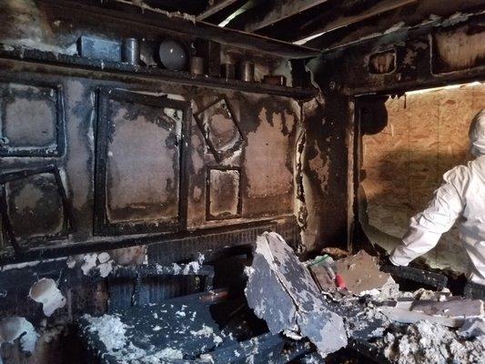 Walls charred and damaged in a home that was damaged in a fire. Doing asbestos testing here.