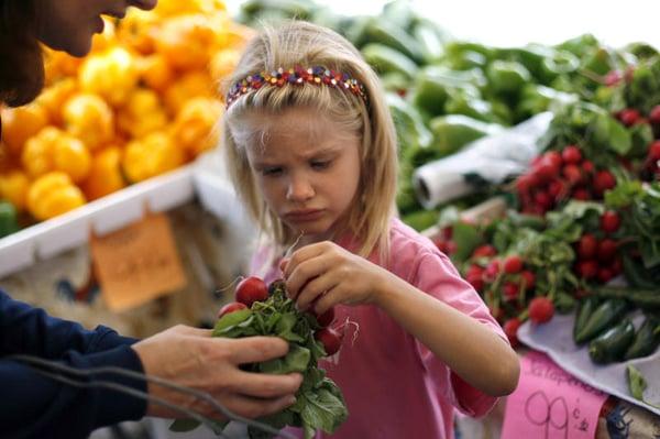 This little girl is helping pick out the family's dinner.  (Photo by Lara Cerri)