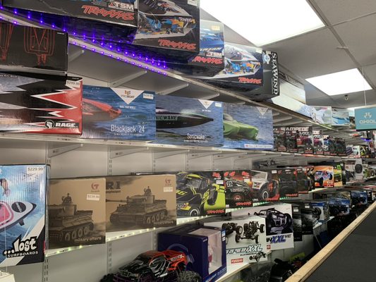 A portion of our wall filled with RC boats, cars, and more!