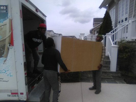 Our team hard working together to navigate an item into the home.