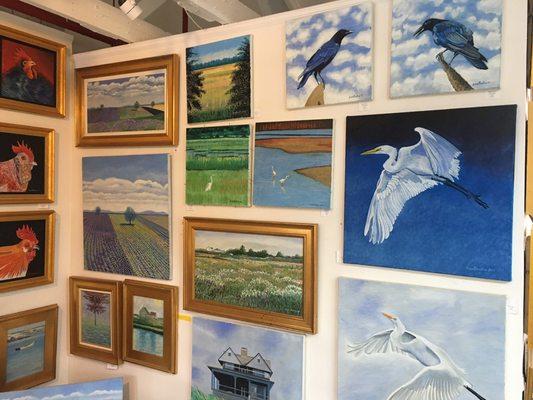 Paintings in the gallery include landscapes and birds.