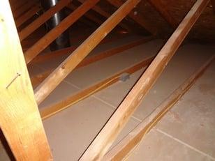 Before: An attic with no insulation, causing the homeowner to lose heat and money.