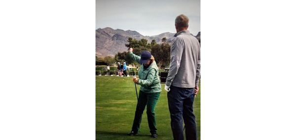 Karen demonstrating the how for a golfer in a private coaching session