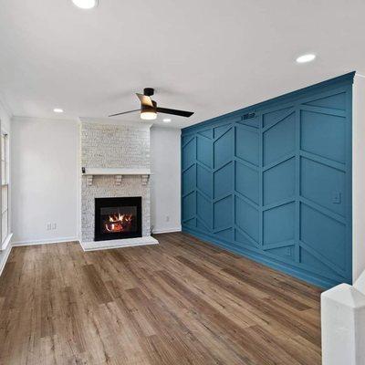 White washed fire place with teal accent wall.