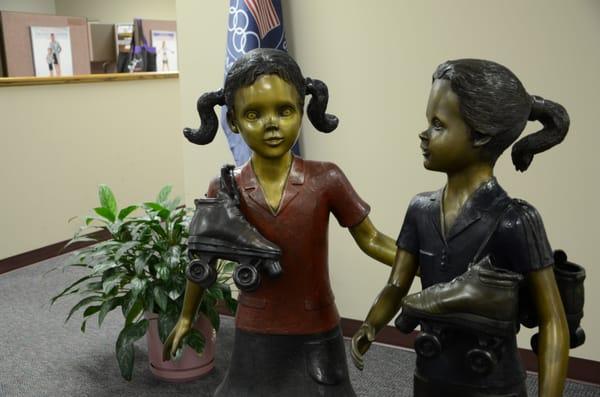 Statues of children in the office area