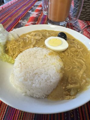 Aji de Gallina - Shredded chicken in a creamy spicy pepper pecan sauce over potatoes with rice.  Delicious!