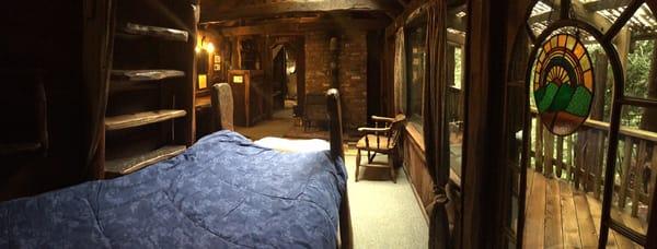 Pan view from small bed in Wood Butcher. See steps up to loft on the far left.