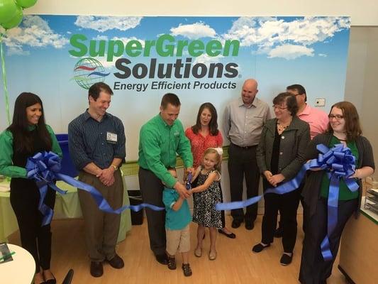 Owner Bryan Pax cuts the ribbon with his children to celebrate the official opening of SuperGreen Solutions.