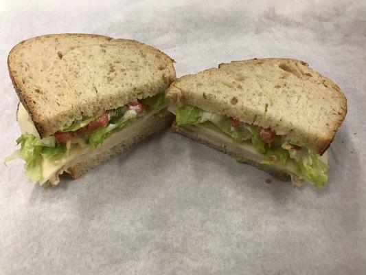 Lunch Your Way: Oven Roasted Turkey, Provolone Cheese, lettuce, tomato, and mayo. Served on Sourdough Bread.