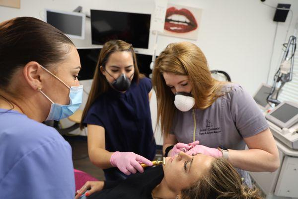 We train in all things Aesthetic Medicine! Our NP Lacey training two other Nurses