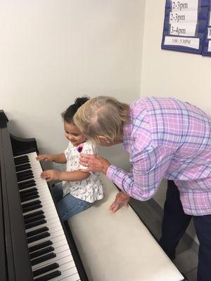 One of the grandmas teaching piano