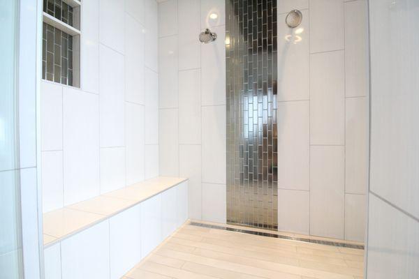 large shower with 12x36 staggered set vertically, barrier free shower with strip drain and glass metallic feature on wall