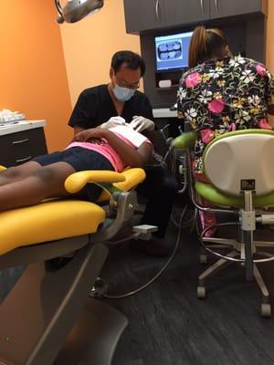 Dakota getting an dental exam , say cheese