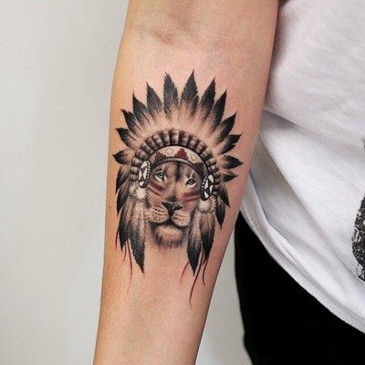 Lion wit native theme tattoo