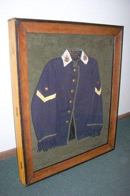 Custom leather shadow box with hinged door to display a removable vintage military jacket