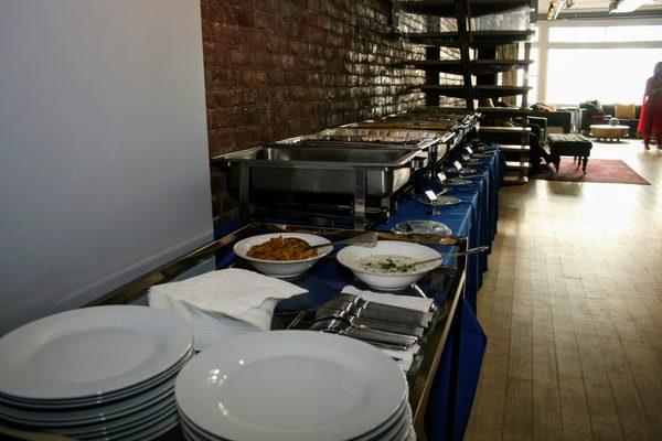 A view of the tablecloth, plates, silverware, bowls and chafing dishes we rented.