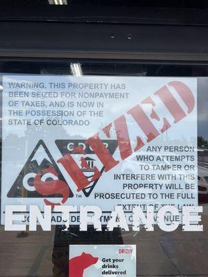 Sign on the door saying that this place has been seized by the state for nonpayment of taxes