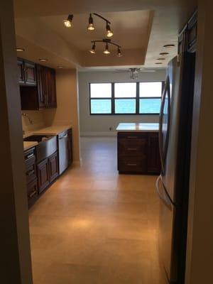 New Kitchen in highrise condo. New cabinets, counter tops with farm sink, lighting, flooring, appliances.