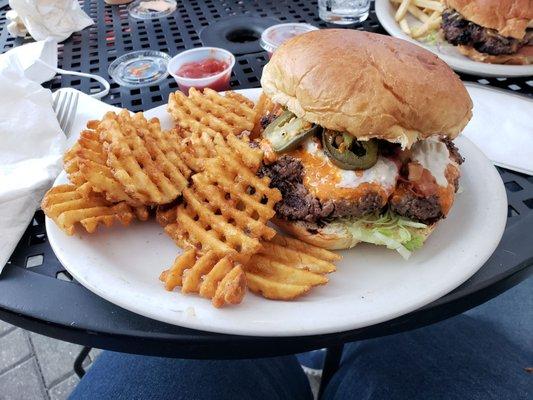 House Special Ricky Bobby burger with waffle fries and added jalapenos