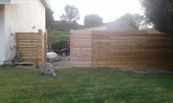 Cedar plank fence and custom rolling gate