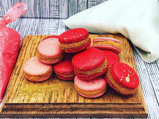 Hazelnut Macarons with a strawberry meringue buttercream and gold sanding sugar and edible gold splatter