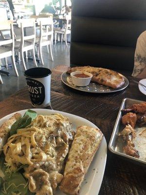 Chicken pasta, pizza calzone with wings.