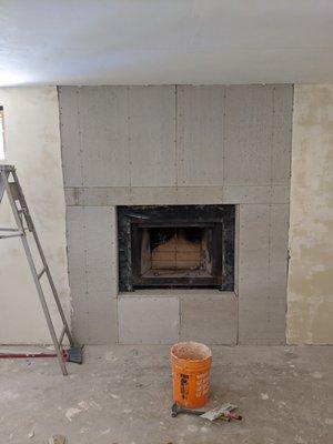 fireplace exposed and wall rebuilt and reinforced with steel for safety before the final covering.