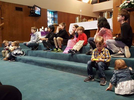 Children listen to a story every Sunday in service before going to their Sunday School classes.