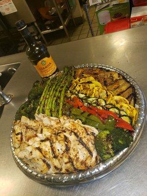 Vegetable platter with grilled chicken.