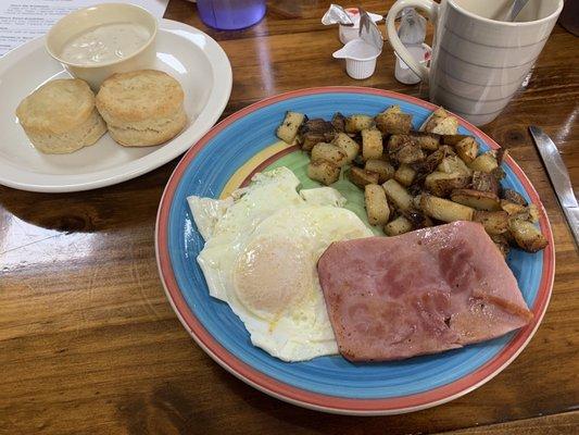 Big Breakfast with ham, home style potatoes, eggs over medium and biscuit  & gravy.